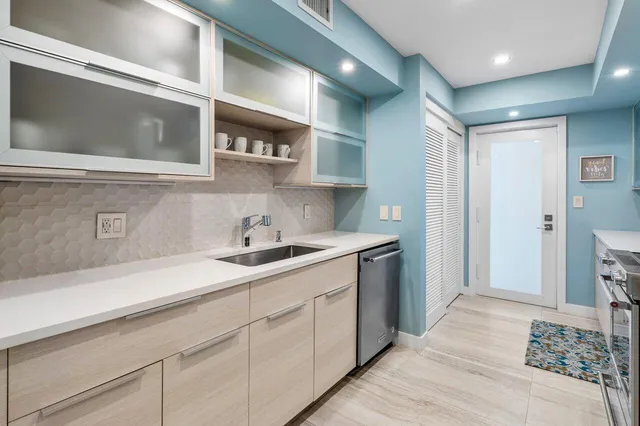 a kitchen with sink cabinets and stove