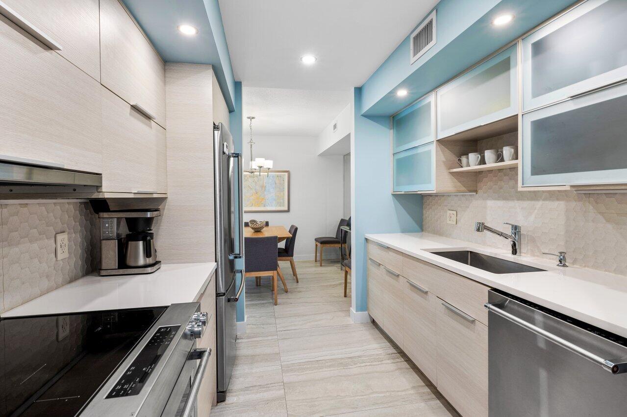 1700 South Ocean Boulevard, Unit 1 Delray Beach, FL 33483 - Photo 18 of 39 a kitchen with sink cabinets and stove