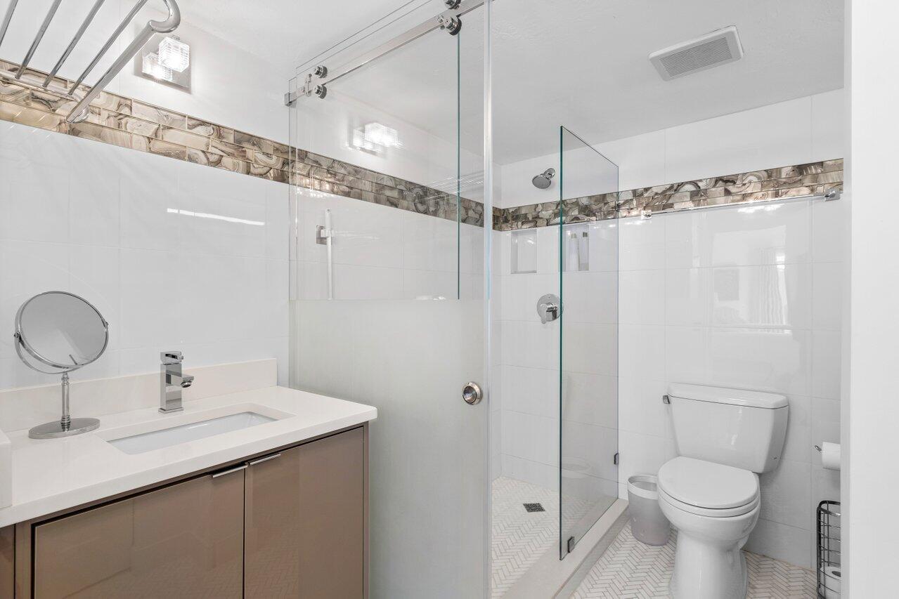 1700 South Ocean Boulevard, Unit 1 Delray Beach, FL 33483 - Photo 21 of 39 a bathroom with a sink toilet and shower