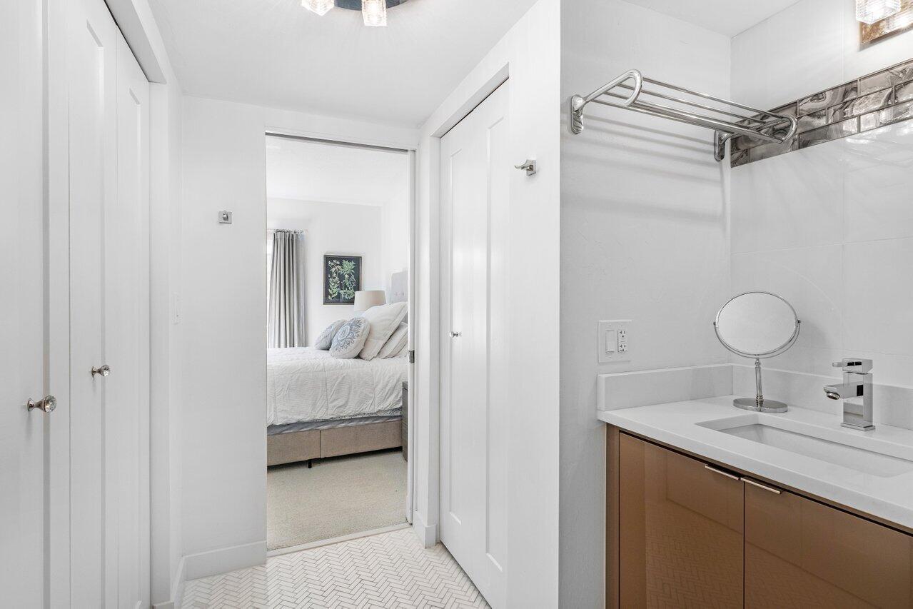 1700 South Ocean Boulevard, Unit 1 Delray Beach, FL 33483 - Photo 23 of 39 a en suite bathroom with a sink a mirror and shower
