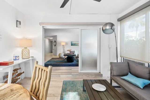 a bedroom with two beds and a painting on the wall