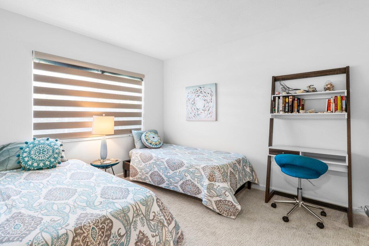 1700 South Ocean Boulevard, Unit 1 Delray Beach, FL 33483 - Photo 25 of 39 a bedroom with two beds and a painting on the wall