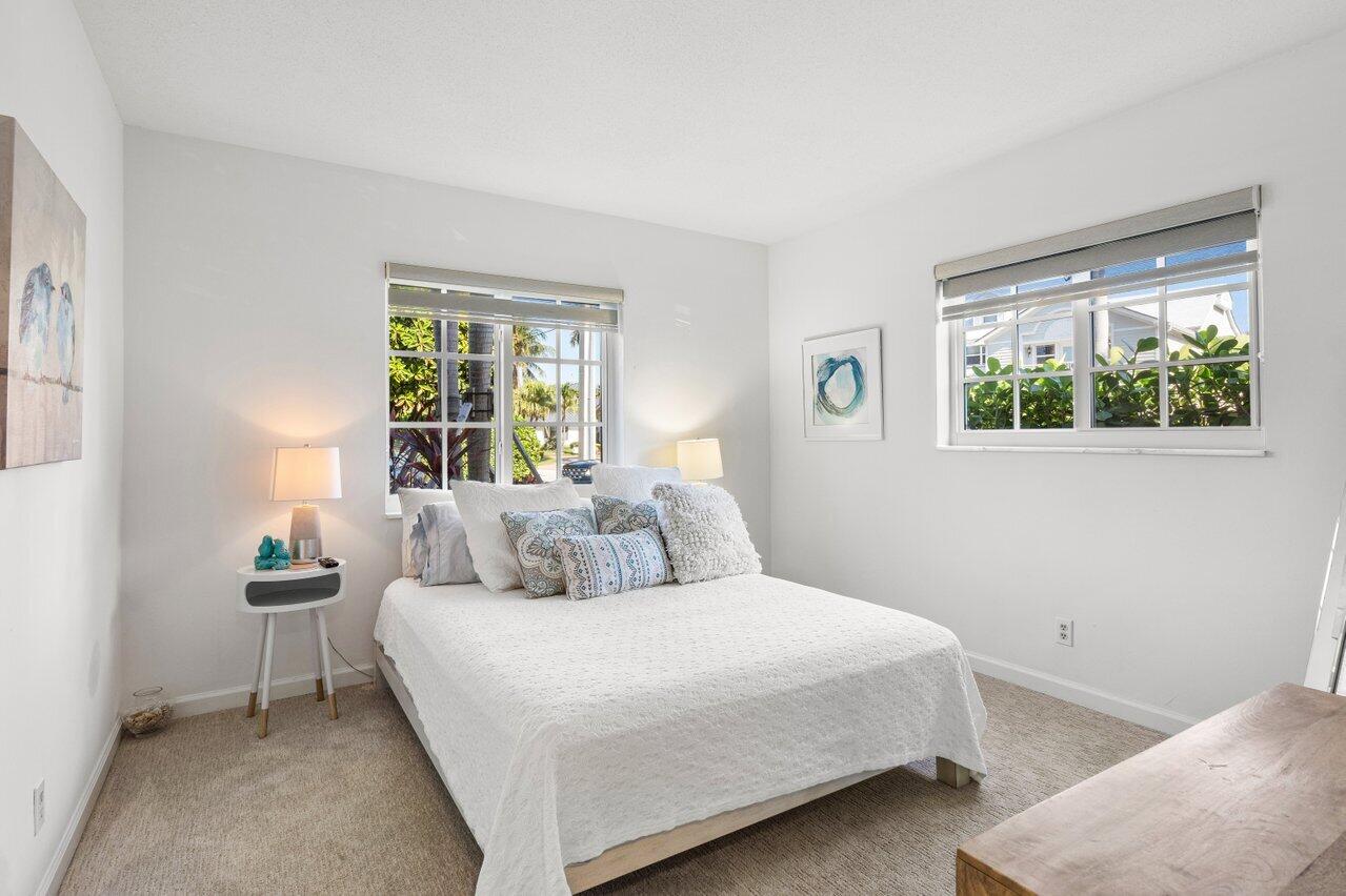 1700 South Ocean Boulevard, Unit 1 Delray Beach, FL 33483 - Photo 26 of 39 a bedroom with a bed and a window