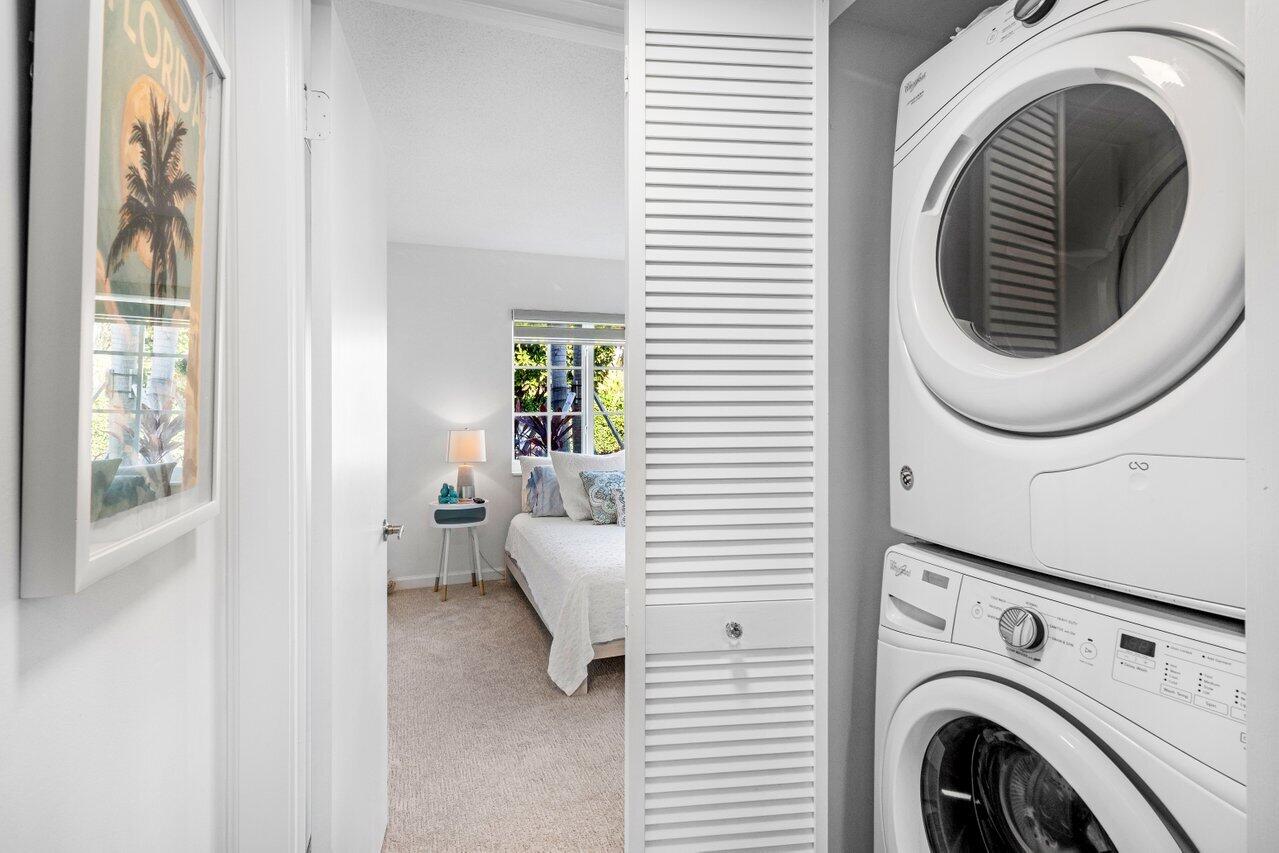 1700 South Ocean Boulevard, Unit 1 Delray Beach, FL 33483 - Photo 28 of 39 a view of a bedroom with washer and dryer