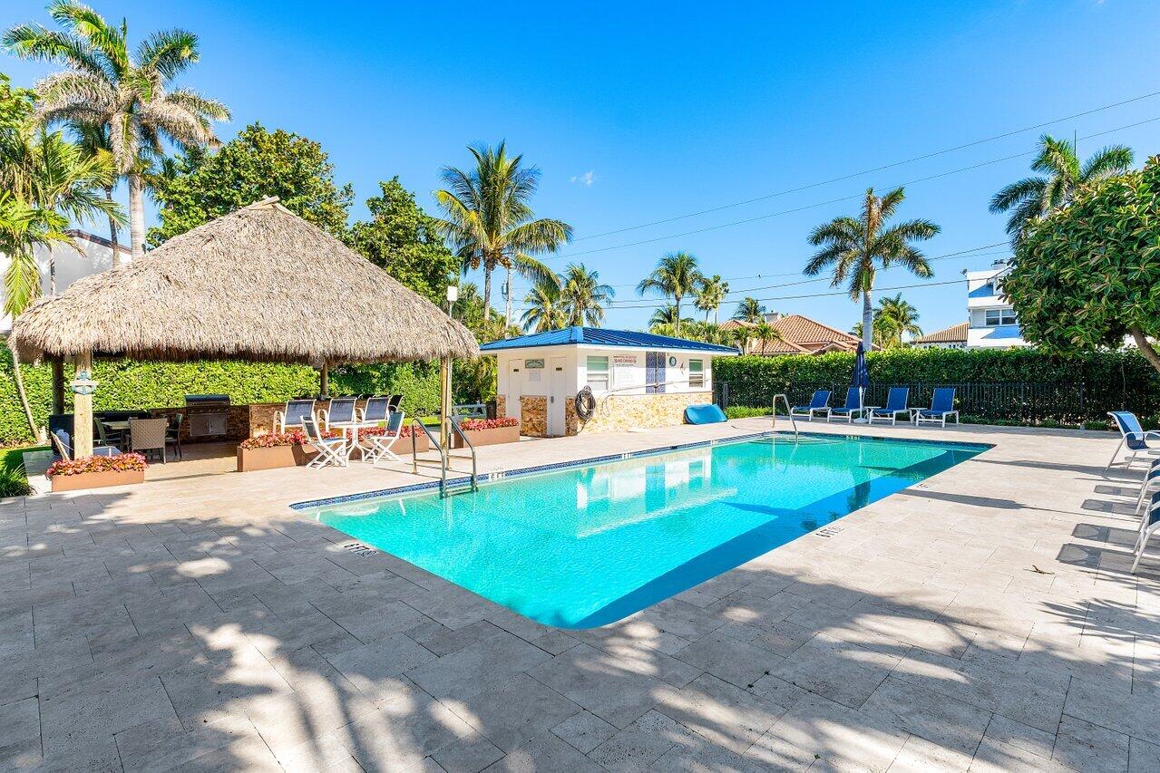 1700 South Ocean Boulevard, Unit 1 Delray Beach, FL 33483 - Photo 29 of 39 a view of a swimming pool with a patio
