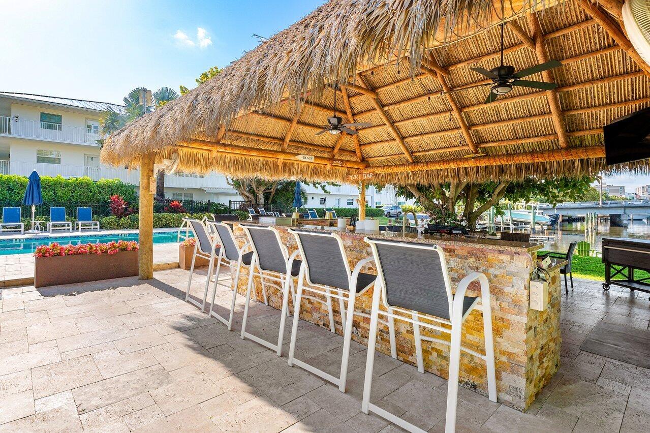 1700 South Ocean Boulevard, Unit 1 Delray Beach, FL 33483 - Photo 31 of 39 a view of a patio with a table and chairs