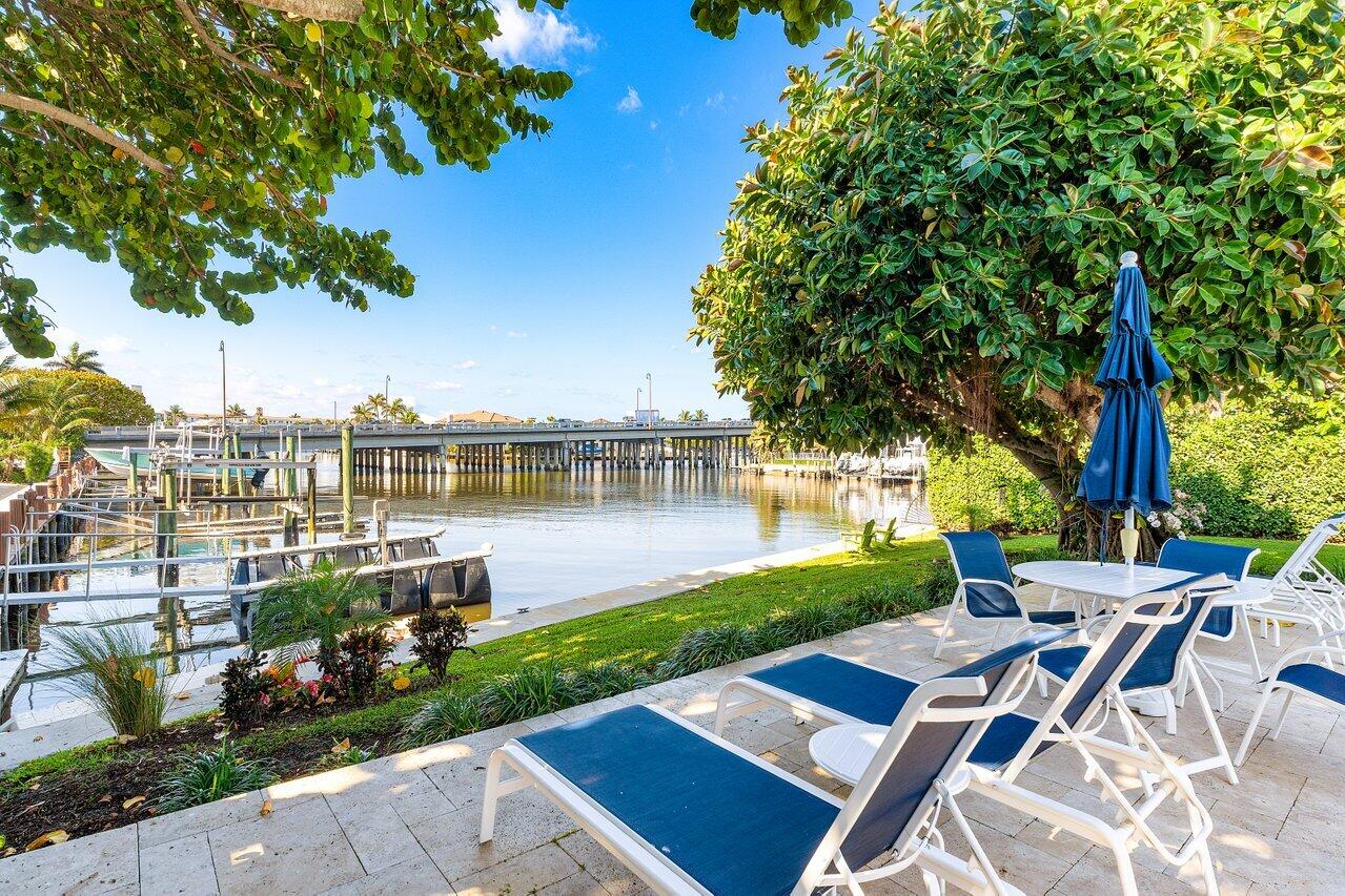 1700 South Ocean Boulevard, Unit 1 Delray Beach, FL 33483 - Photo 33 of 39 a view of a patio with table and chairs potted plants and large tree