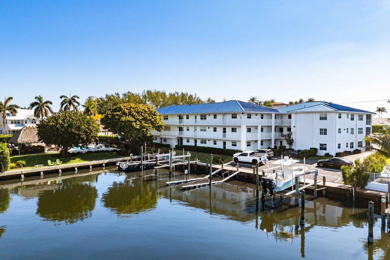 1700 South Ocean Boulevard, Unit 1 Delray Beach, FL 33483 - Photo 8 of 39 a view of a lake with building in front