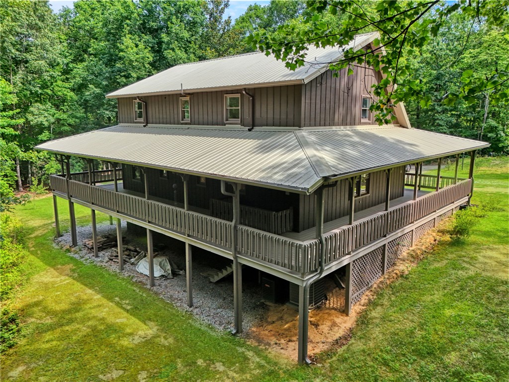 120 Patterson Ridge Road Salem, SC 29676 - Photo 29 of 46 Perched among verdant trees, this charming home offers a spacious wraparound porch for outdoor enjoyment.