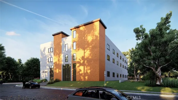 a front view of a building with tree s