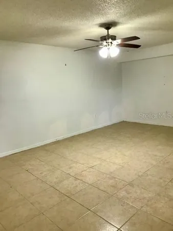 a view of a room with window and ceiling fan