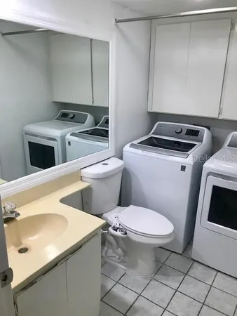 a bathroom with a sink toilet and granite top