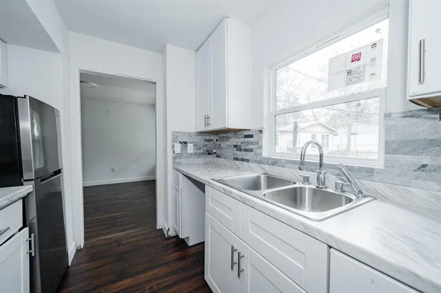 a kitchen with a sink cabinets and a window