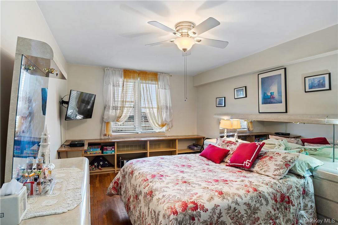 525 West 236th Street, Unit 5B Bronx, NY 10463 - Photo 13 of 18 a bedroom with a bed and a chandelier