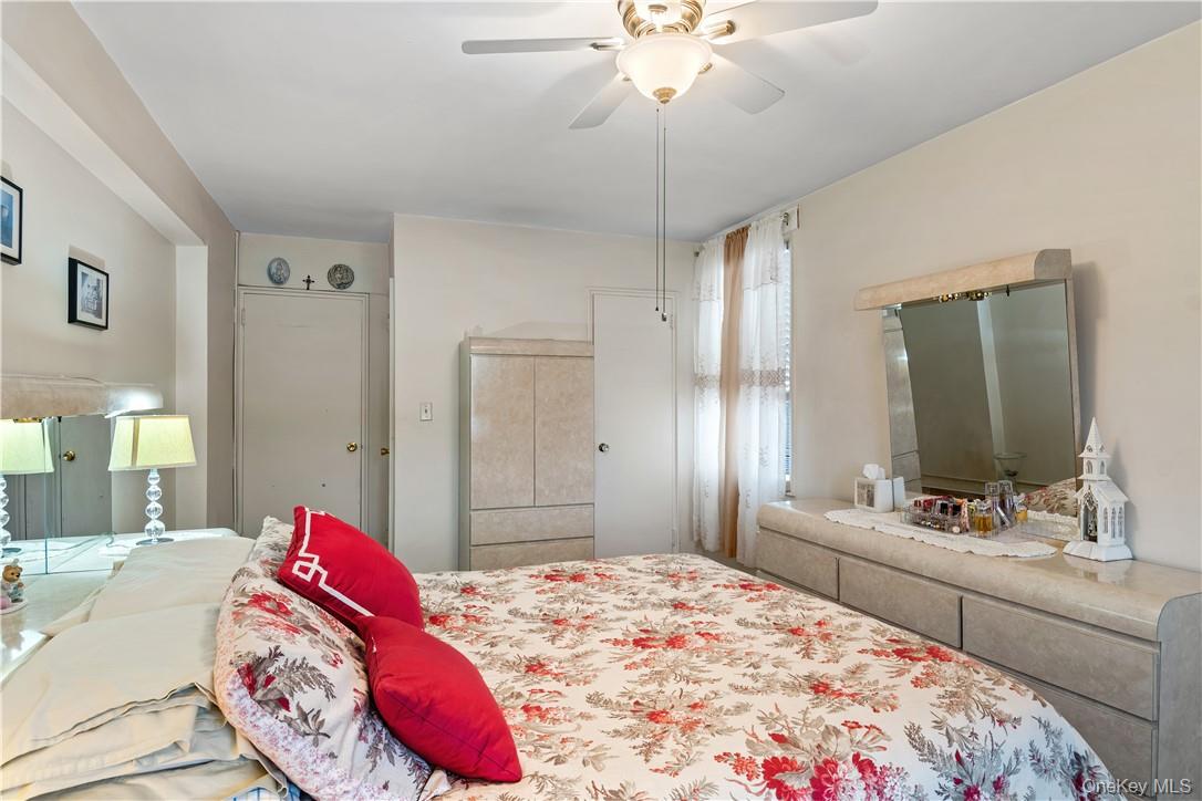 525 West 236th Street, Unit 5B Bronx, NY 10463 - Photo 14 of 18 a bedroom with a bed and a chandelier