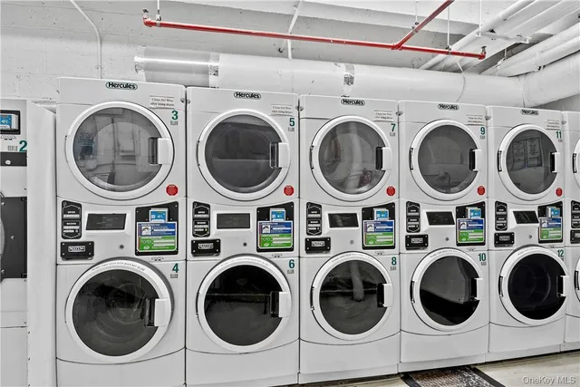 a utility room with dryer washer and a washing machine