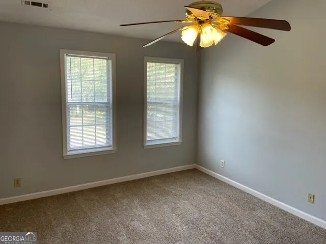 a view of a chandelier fan and a window