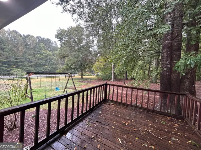 a view of balcony with wooden floor and fence