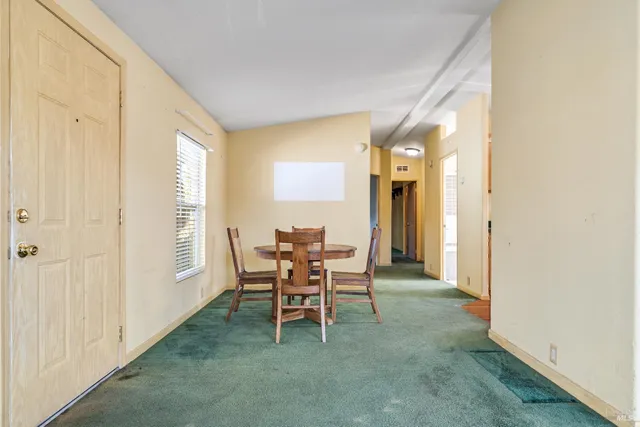 a dining room with furniture and window