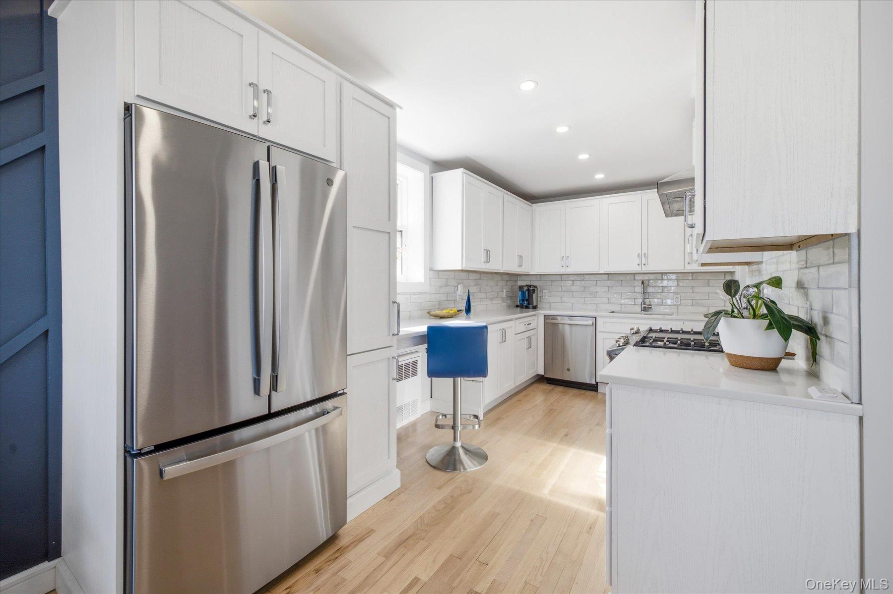 522 Shore Road, Unit 3BB Long Beach, NY 11561 - Photo 8 of 27 Brand new kitchen featuring white cabinetry, stainless steel appliances, and a subway tile backsplash