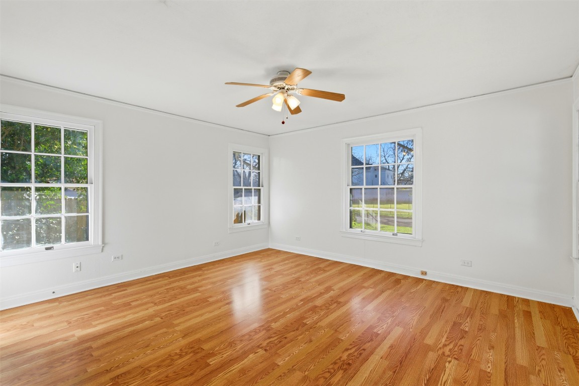1506 Grace Street Taylor, TX 76574 - Photo 11 of 21 2nd bedroom with light flooring, crown molding, plenty of natural light, ceiling fan and a half-bath
