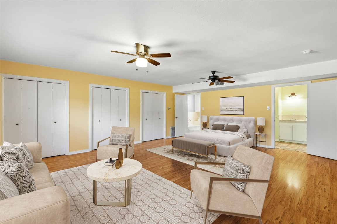 1506 Grace Street Taylor, TX 76574 - Photo 15 of 21 Virtually staged secondary suite or 3rd bedroom featuring three closets, light wood-style floors, ceiling fan, and ensuite bathroom.