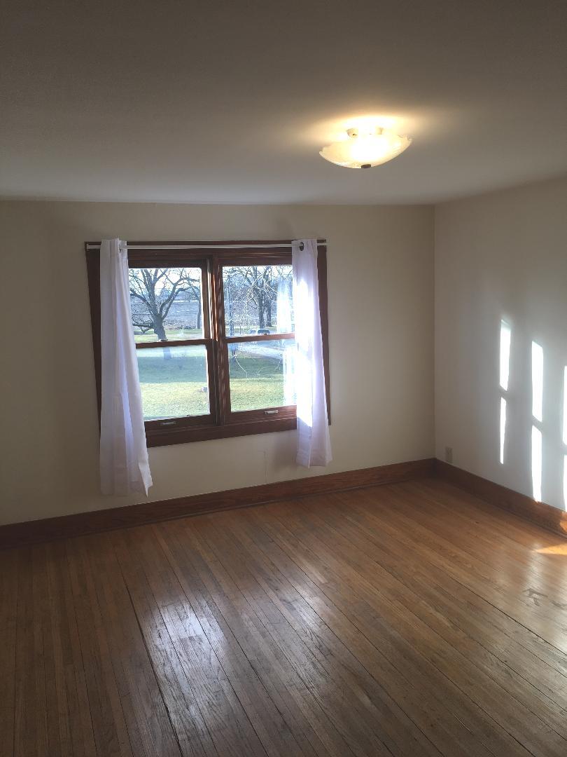 13078 Church Road Yorkville, IL 60560 - Photo 16 of 22 an empty room with wooden floor and windows