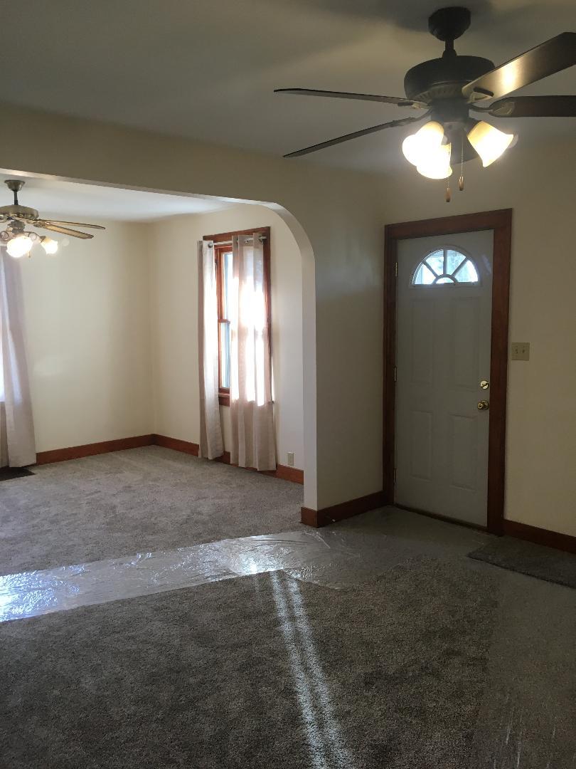 13078 Church Road Yorkville, IL 60560 - Photo 4 of 22 an empty room with chandelier fan and windows