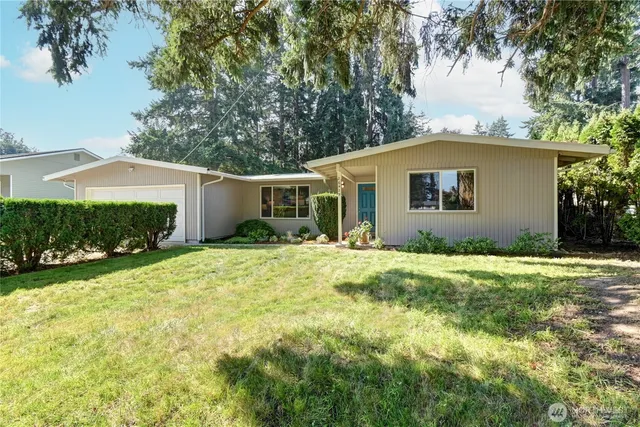 a front view of house with yard and green space