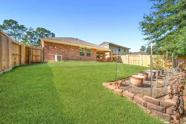 a view of a house with a yard and sitting area
