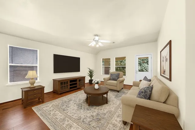 a living room with furniture a flat screen tv and a fireplace