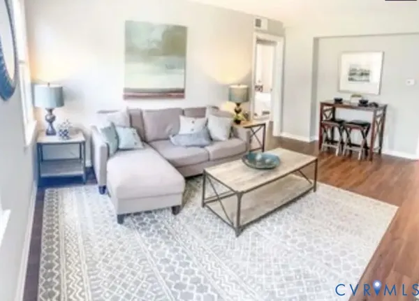 a living room with furniture and wooden floor