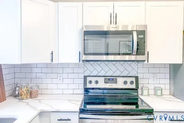 a stove top oven sitting inside of a kitchen