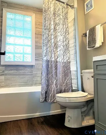 a bathroom with a toilet and a shower