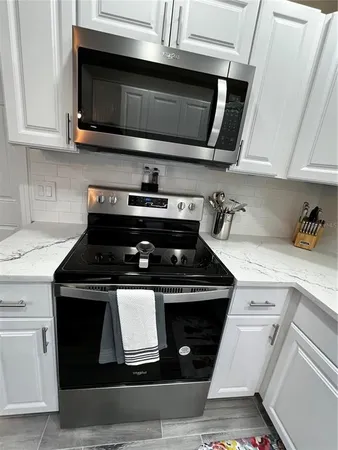 a stove top oven sitting inside of a kitchen and granite counter tops