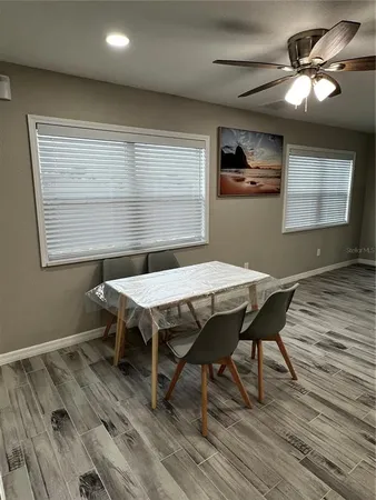 a view of a dining room with furniture window and wooden floor