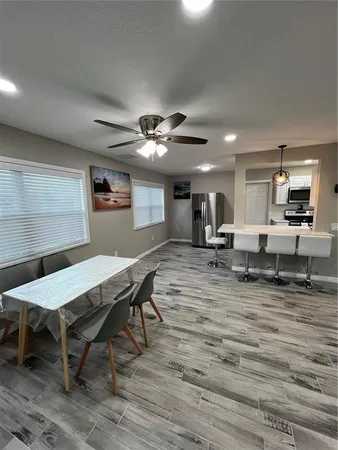 a room with furniture pool table and window