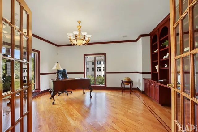 a dining room with furniture potted plants and wooden floor