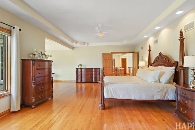 a view of a room with wooden floor and ceiling fan