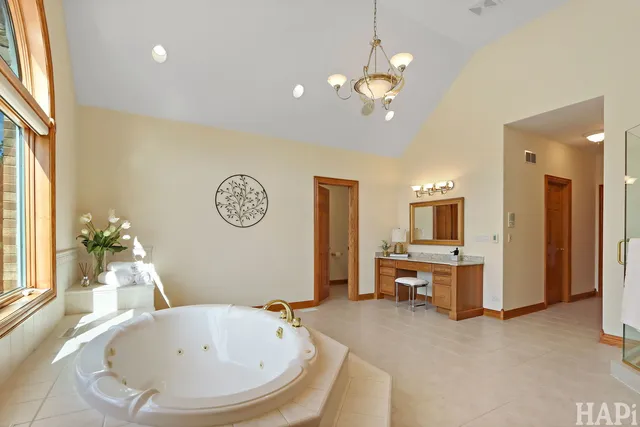 a living room with furniture a fireplace and a large window