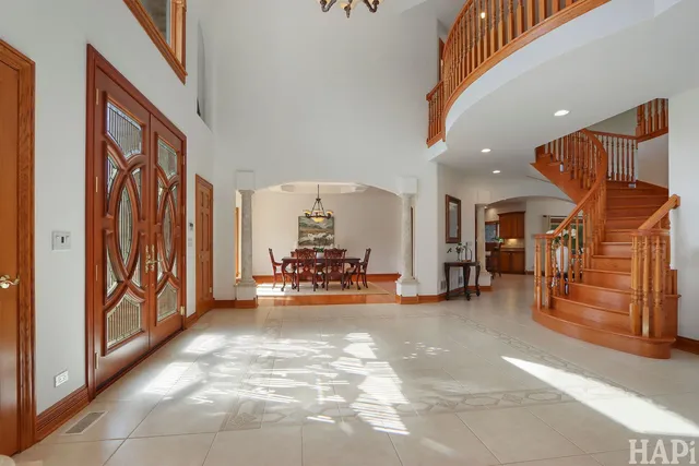 a living room with furniture fireplace and a large window
