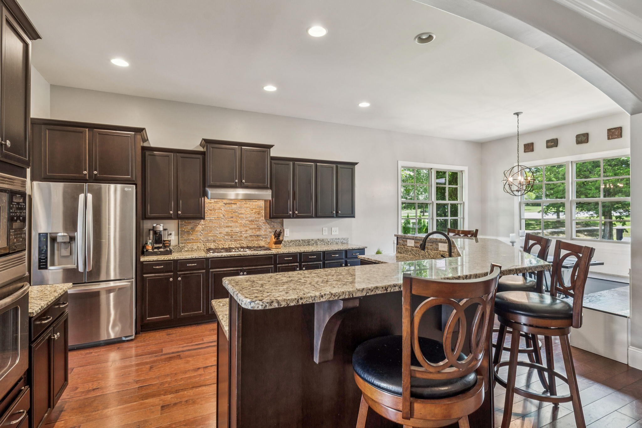 1501 Registry Row Arrington, TN 37014 - Photo 12 of 77 a kitchen with kitchen island granite countertop a sink stove and refrigerator