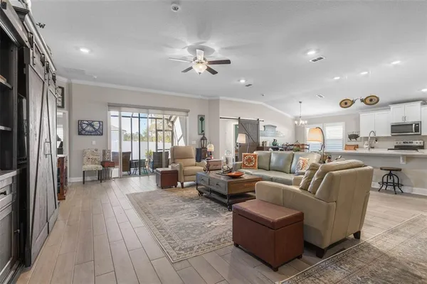 a living room with furniture kitchen view and a table