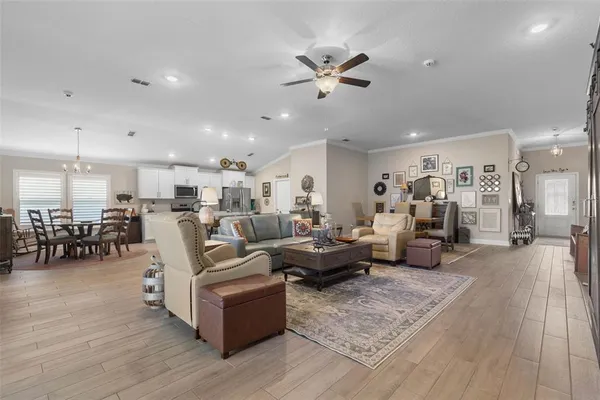 a living room with furniture and a view of kitchen