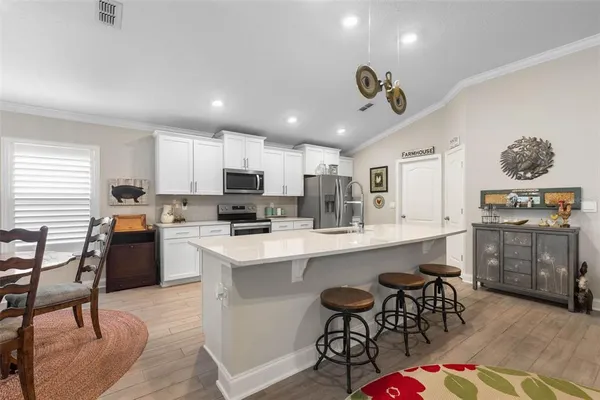 a kitchen with a refrigerator stove and microwave