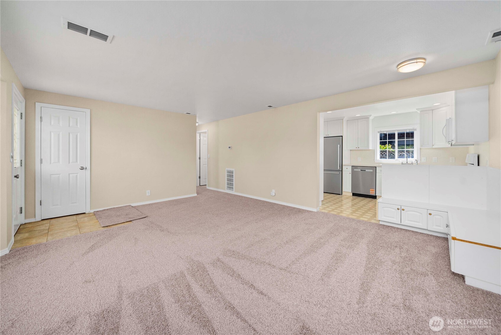 1617 Northeast 28th Street Renton, WA 98056 - Photo 6 of 33 a view of a kitchen with wooden floor and a refrigerator
