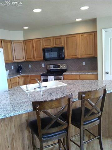 9275 Rockingham Drive Peyton, CO 80831 - Photo 9 of 26 Granite Countertops, Tile Backsplash.