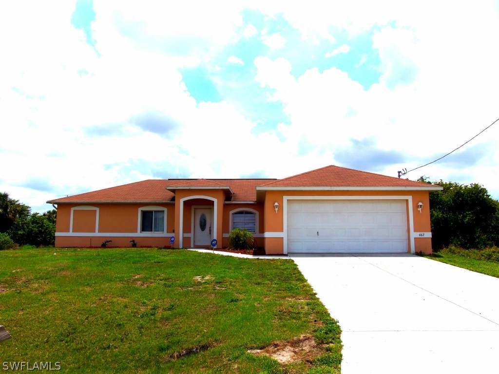462 Rajah Street Lehigh Acres, FL 33974 - Photo 1 of 17 a front view of a house with a garden and yard