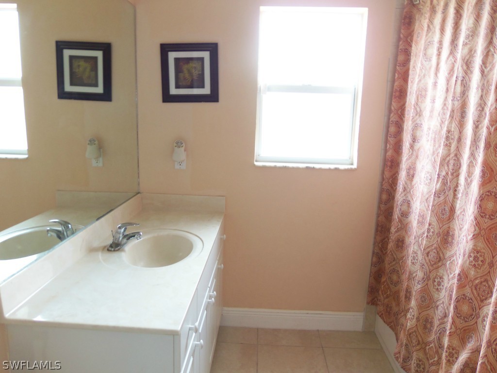 462 Rajah Street Lehigh Acres, FL 33974 - Photo 12 of 17 a bathroom with a sink and a window
