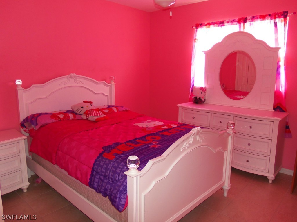 462 Rajah Street Lehigh Acres, FL 33974 - Photo 13 of 17 a bedroom with a bed and a dresser